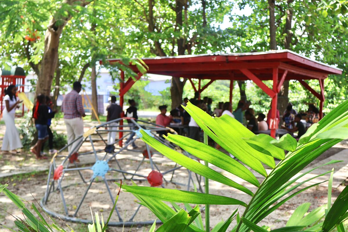 Boost Academy participants gathered in the shaded outdoor learning area